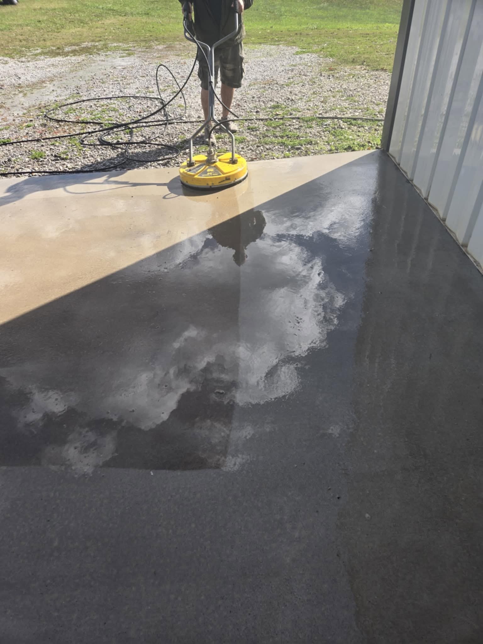 Industrial concrete surface being cleaned with a rotary disc