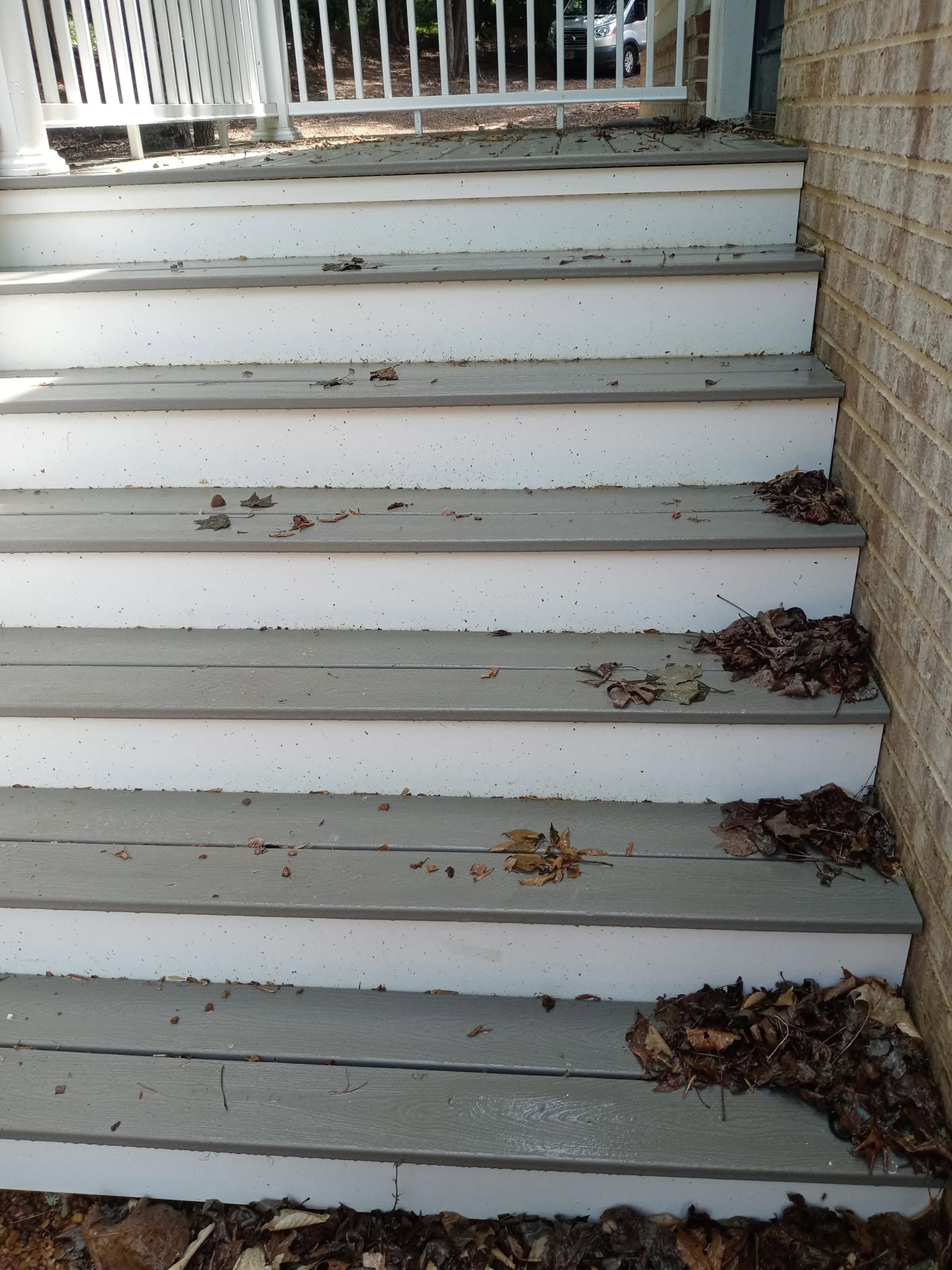 Multi-tier composite staircase with grime buildup before cleaning