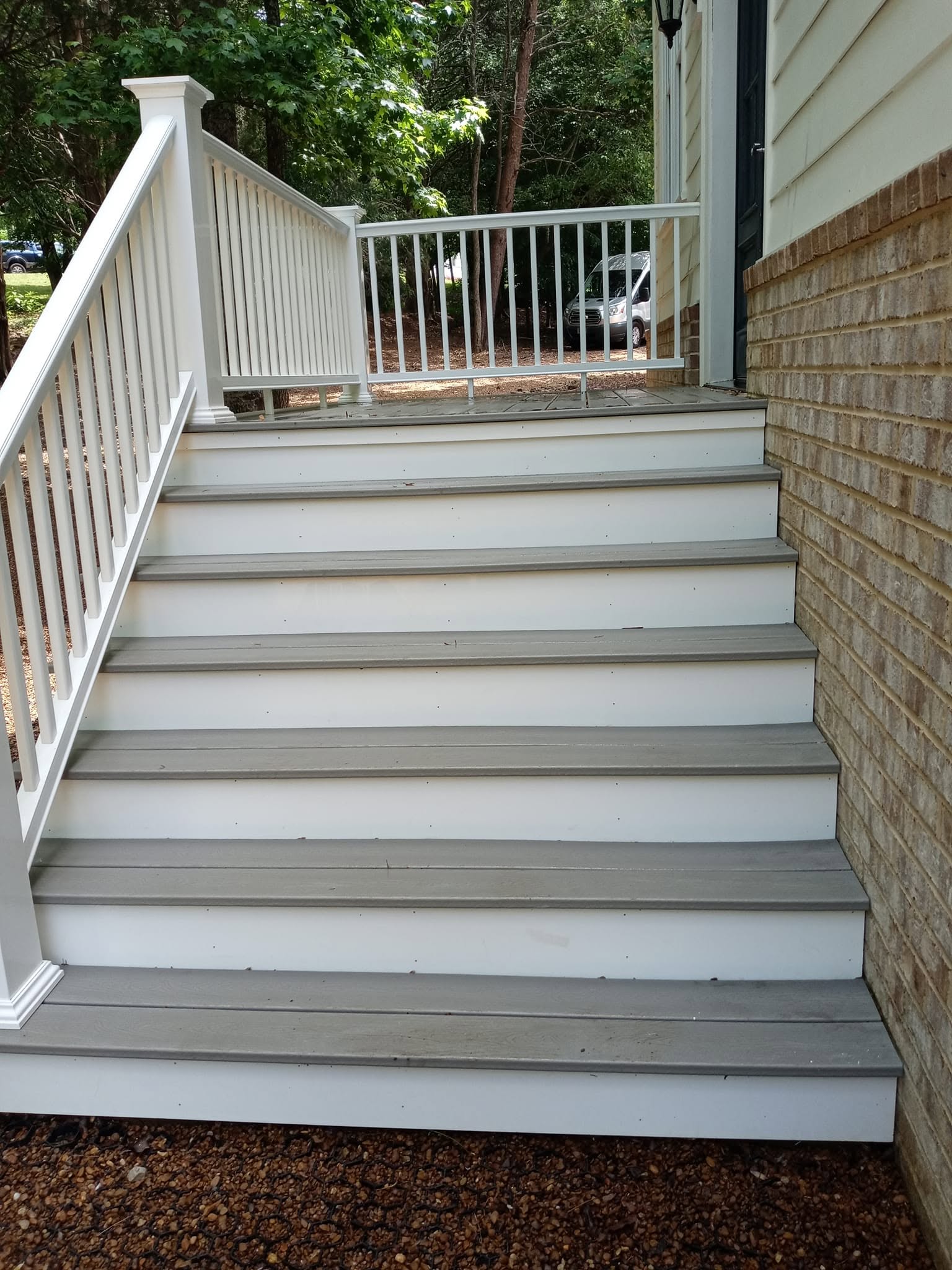 Same multi-tier composite staircase after deck cleaning — fully restored