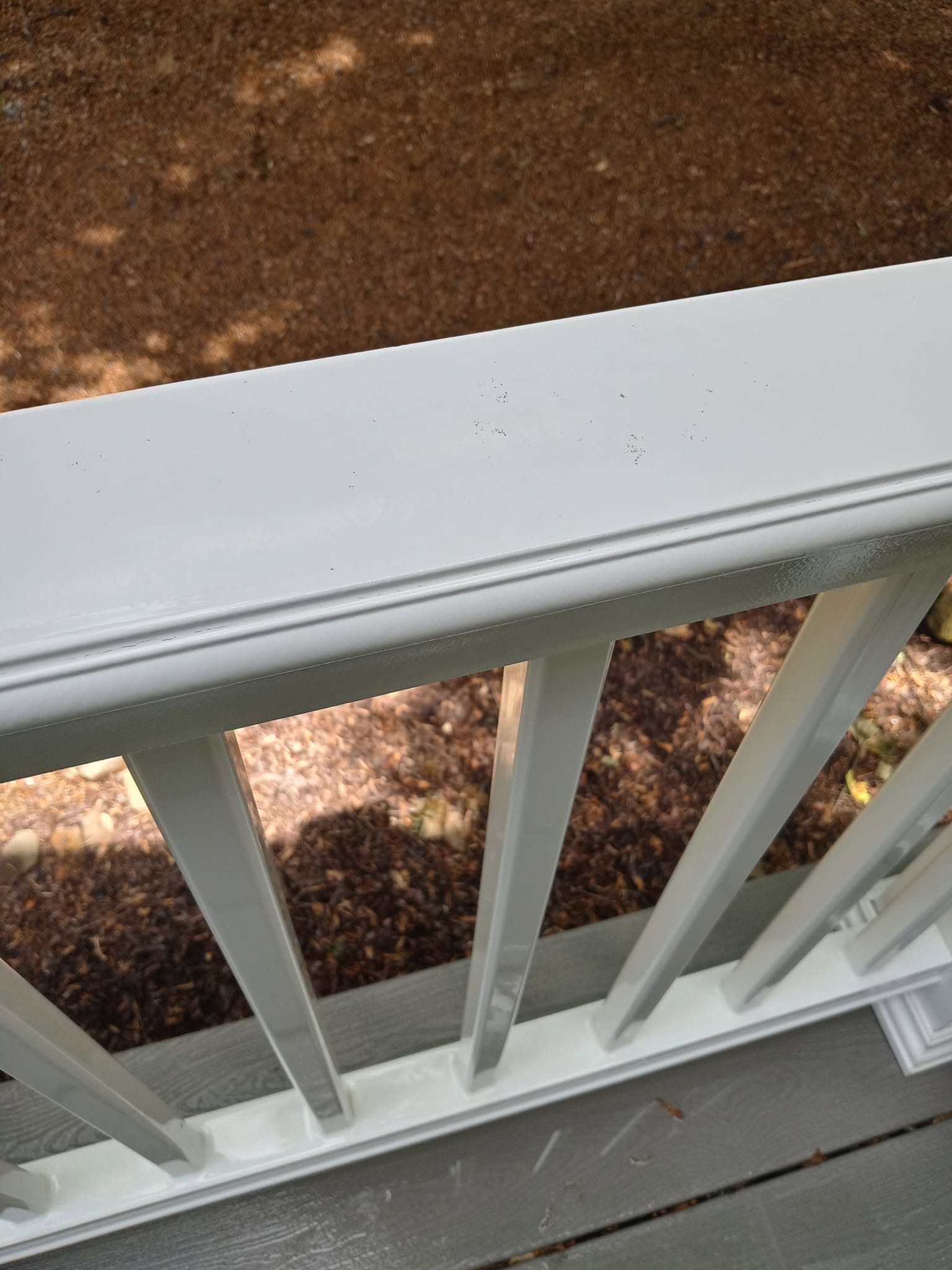 Same white vinyl handrail after cleaning — bright and like-new