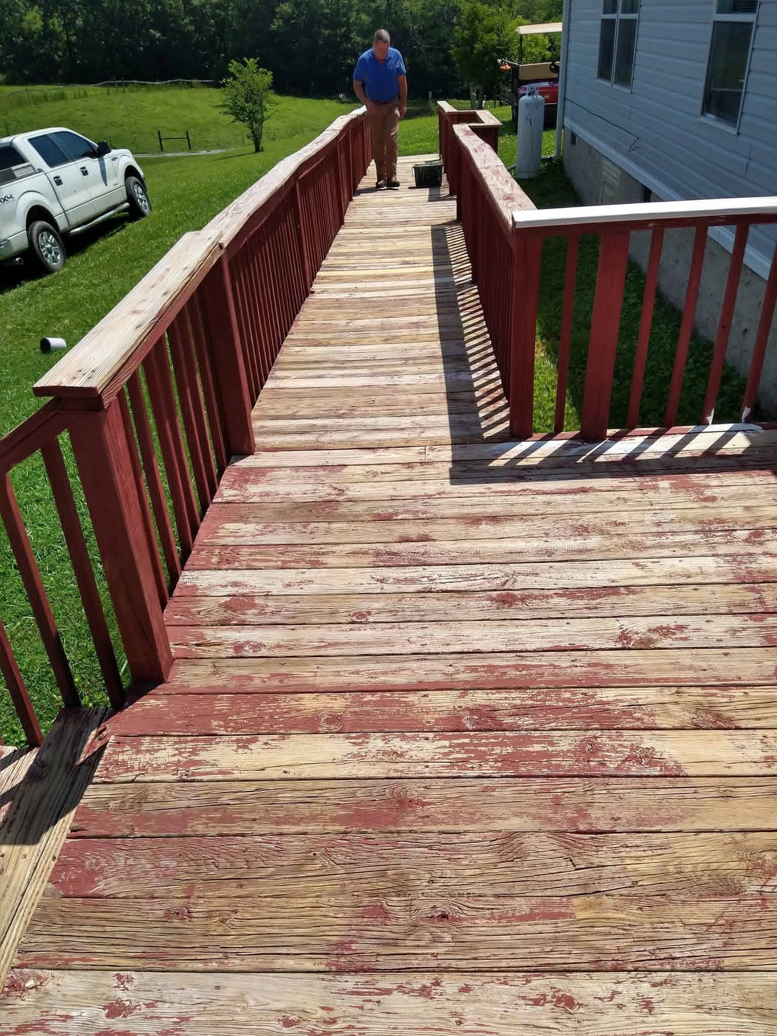 Elevated wooden ramp with weathered finish before restoration