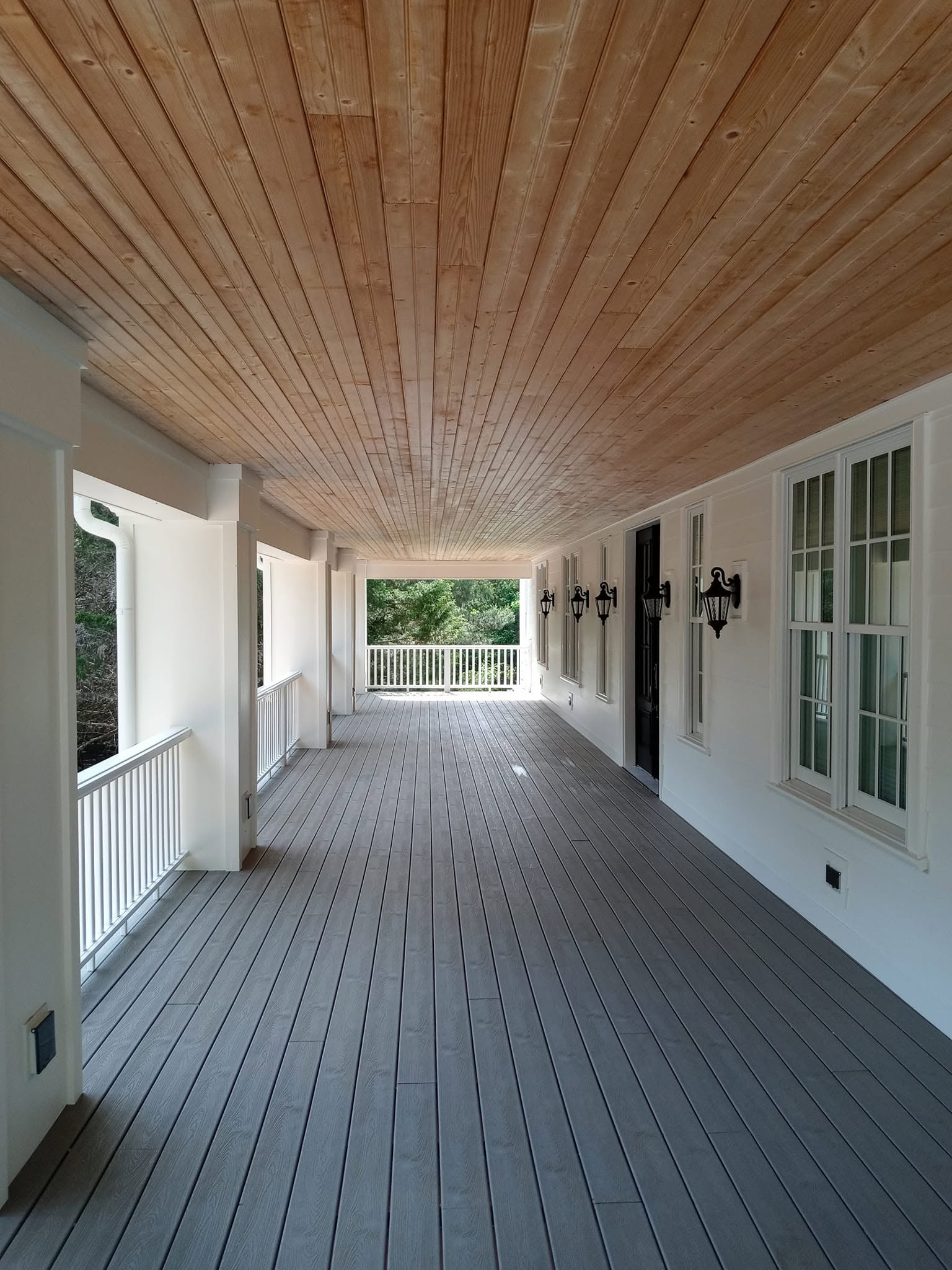 Restored multi-story covered porch on colonial home