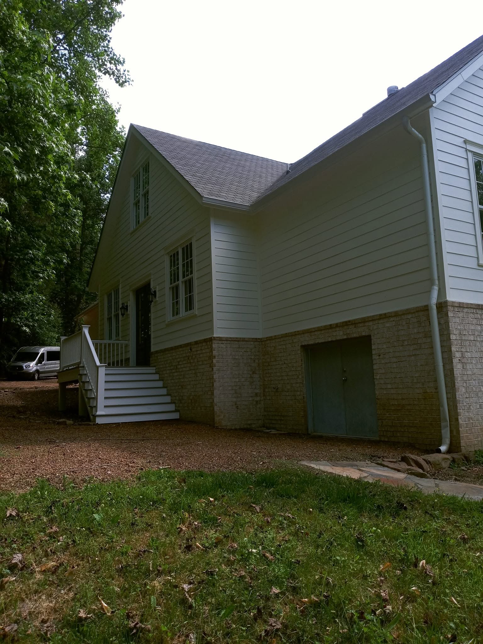 Luxury estate after soft-wash cleaning of siding and brick foundation