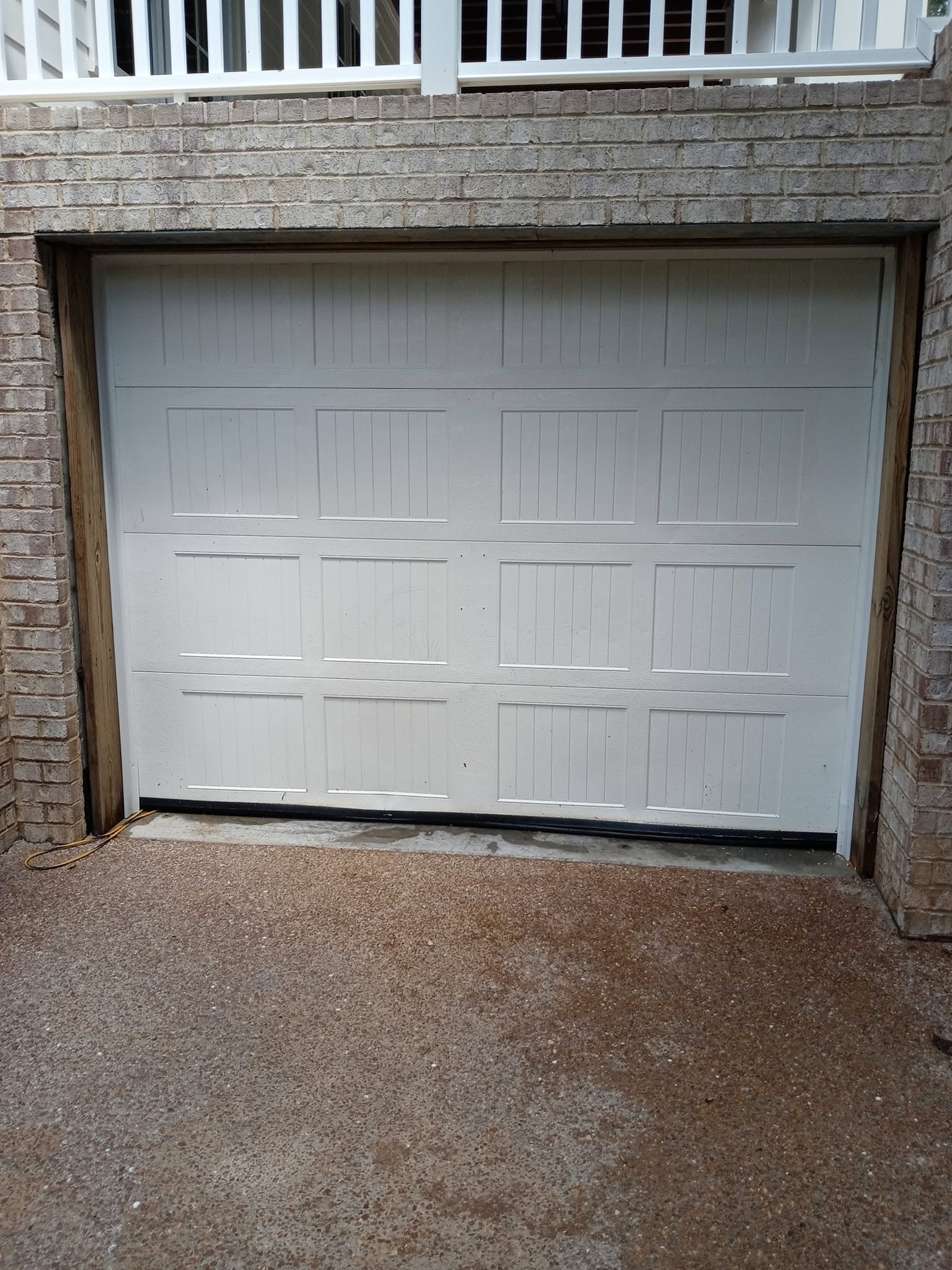Same garage door surround after house wash — clean siding and trim