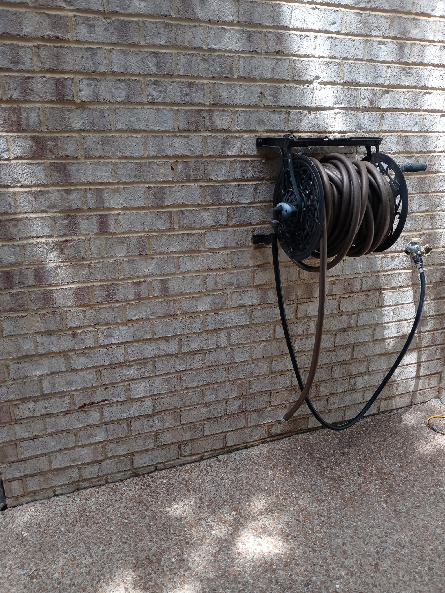 Same brick masonry wall after pressure washing — clean and bright